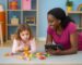 Therapist and girl laying on floor with blocks
